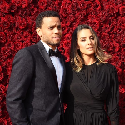 Khatira Rafiqzada and Michael Ealy in matching black outfits.